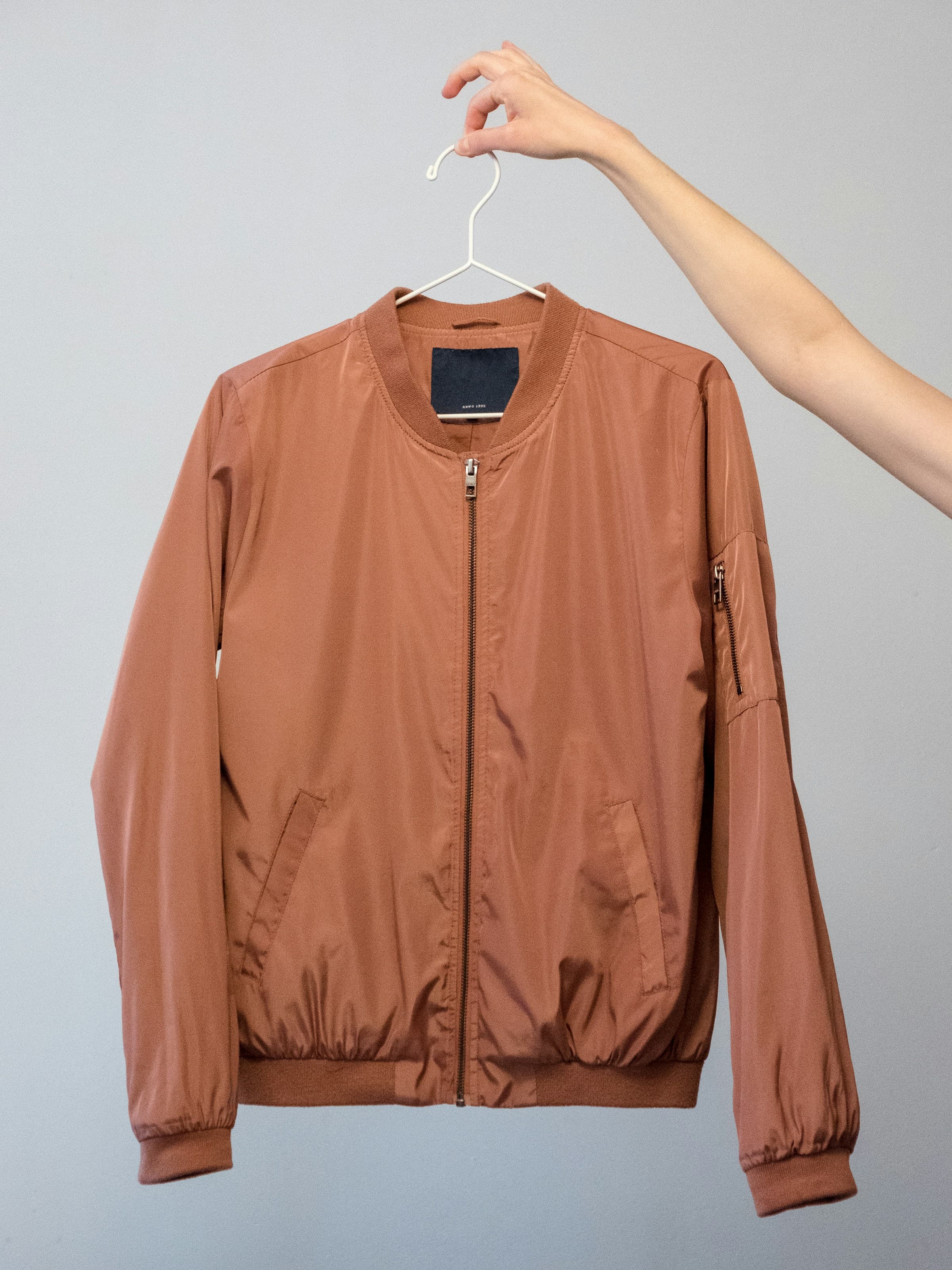 A bomber jacket held up on a hanger
